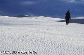 Man walking on sand dunes